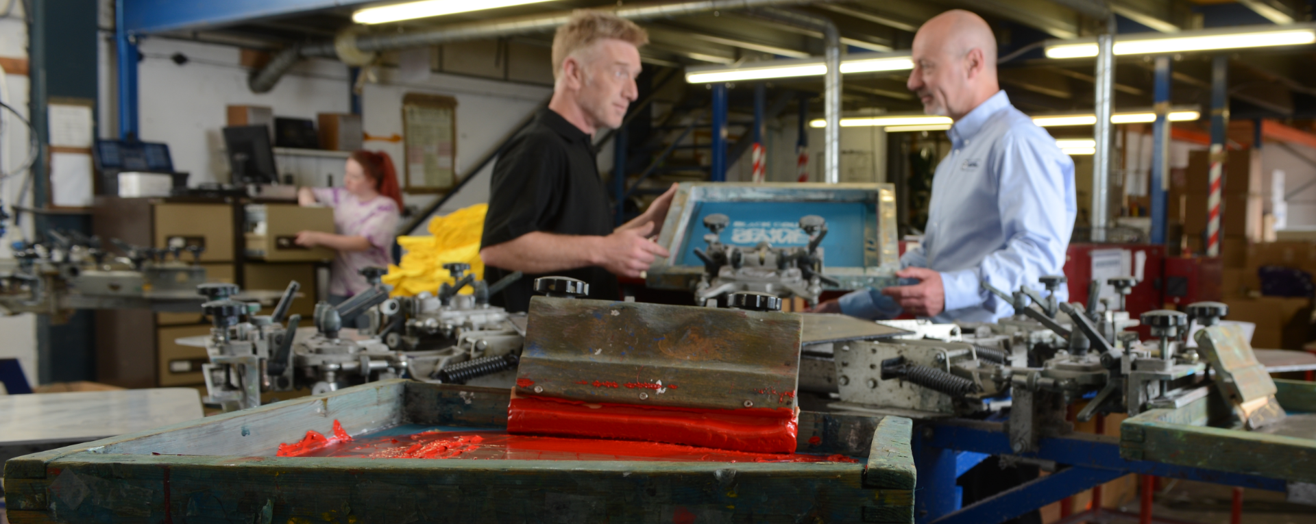 Shaun Staunton and Gary Smith next to Advance Printwear screen printing machines